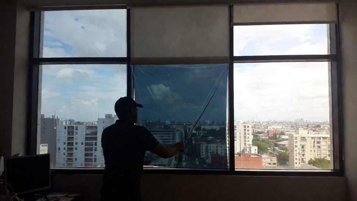 person installing commercial window film image