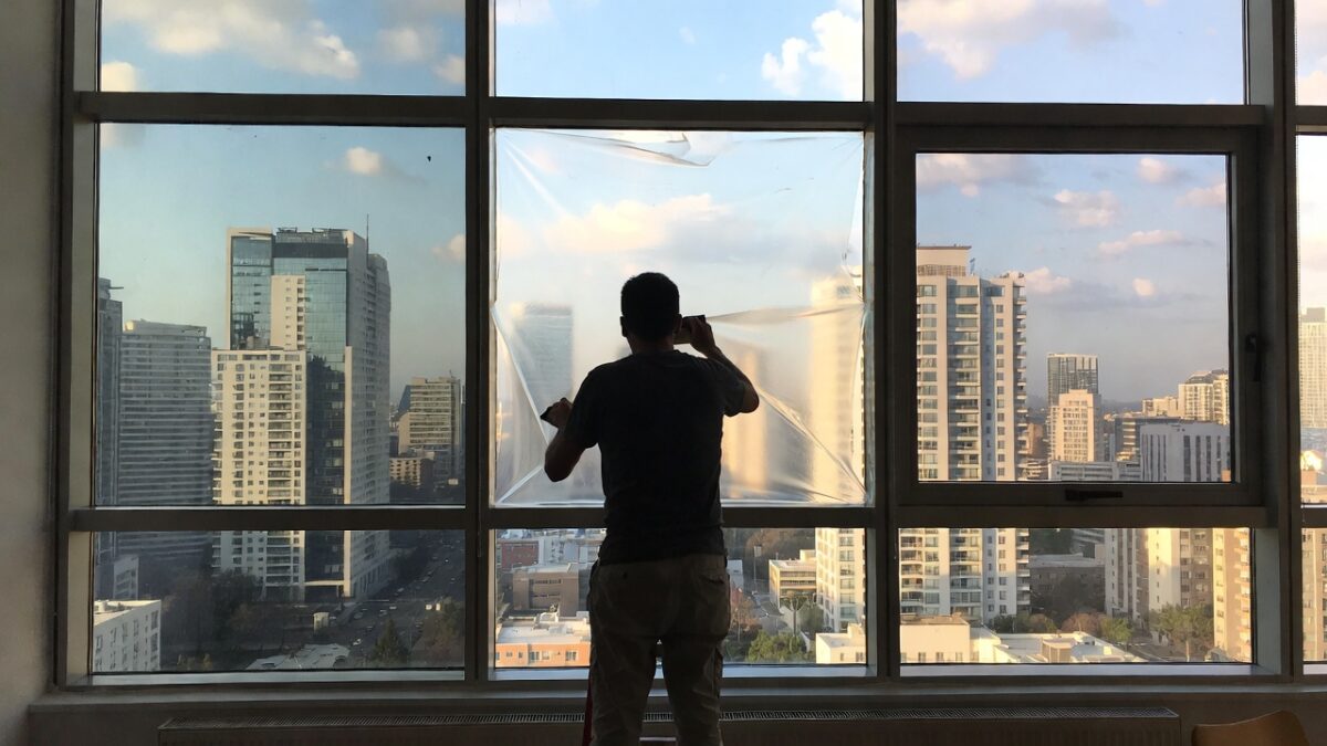 person installing commercial window film image